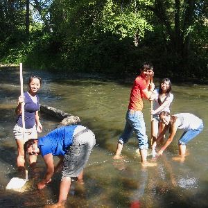 teenagers in the creek with nets