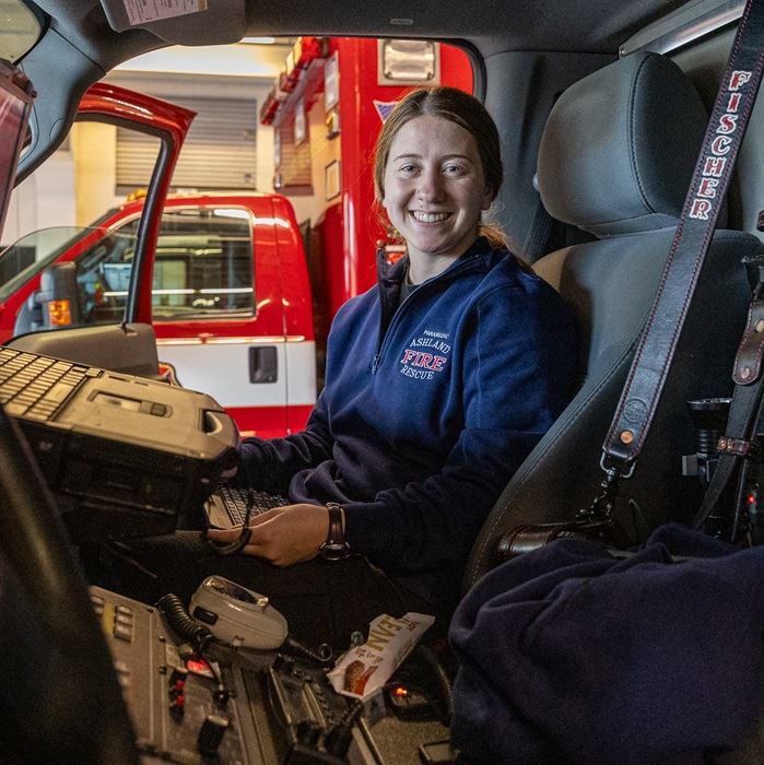 Young professional woman sitting in an ambulance