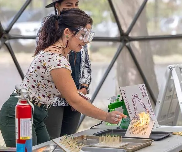 woman doing a scientific fire demonstration