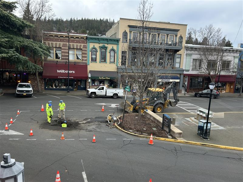 Crews address a water leak on a city street