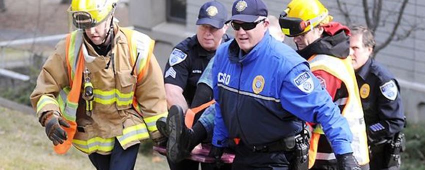 Police and first responders carrying a person on a stretcher